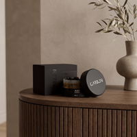 Carbon ASH ma'moul box and open jar on a walnut console