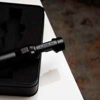 Carbon Ignis torch lighter resting on its case
