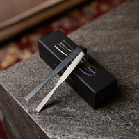 Carbon Grip charcoal tongs leaning on their box
