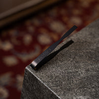 Carbon Grip tongs resting on a stone edge