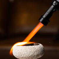 Carbon Ignis torch lighter flame over a stone mabkhar