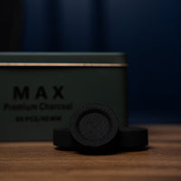 Carbon Max tin with charcoal pieces in front