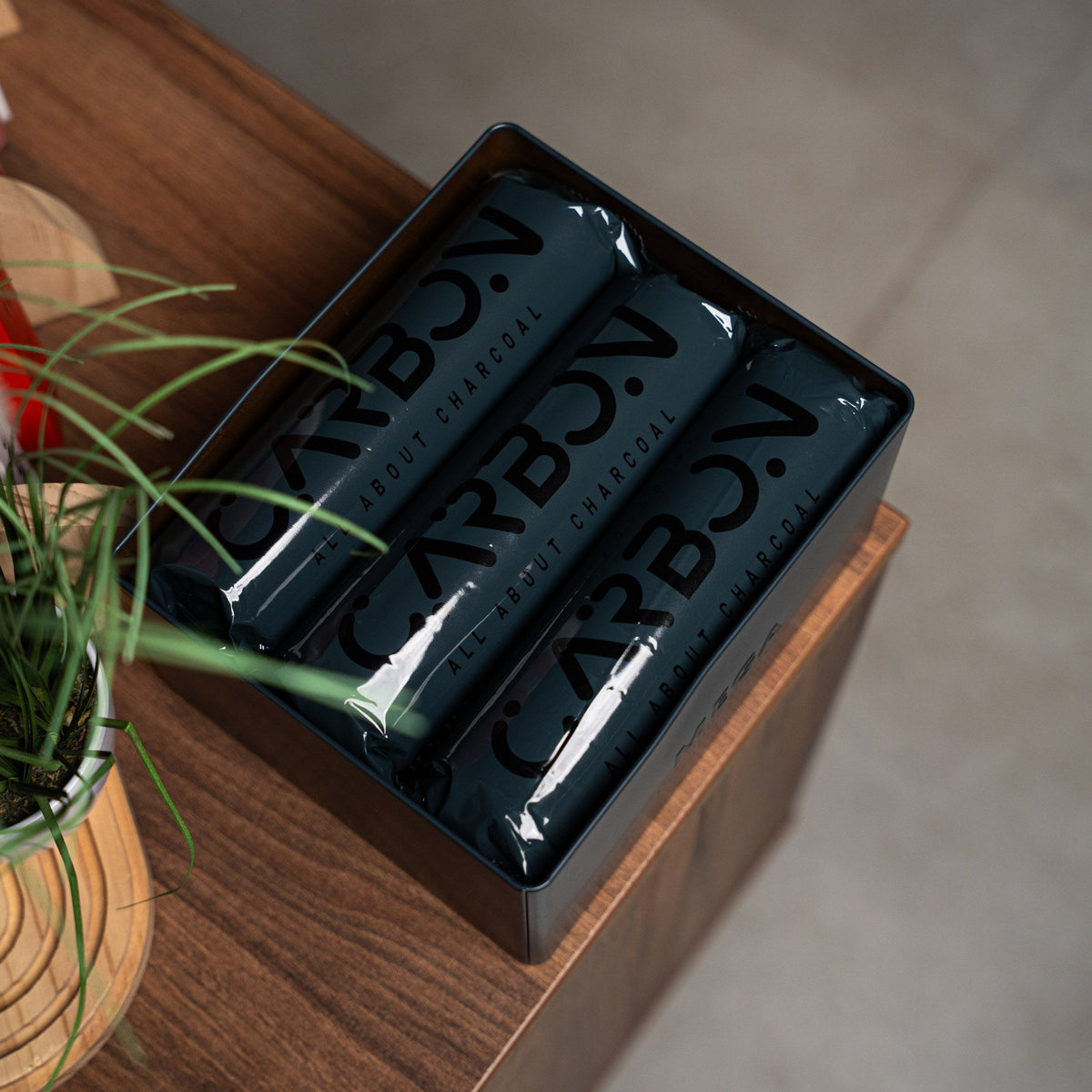 Carbon Mega charcoal rolls in an open tin
