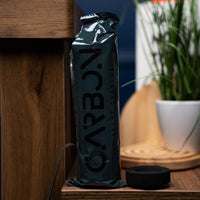 Carbon Mega charcoal roll standing beside a charcoal piece