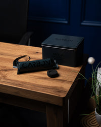 Carbon Mega tin and roll on a wooden desk