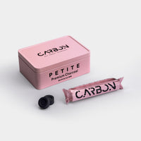 Carbon Petite 22mm pink tin with a roll and charcoal pieces