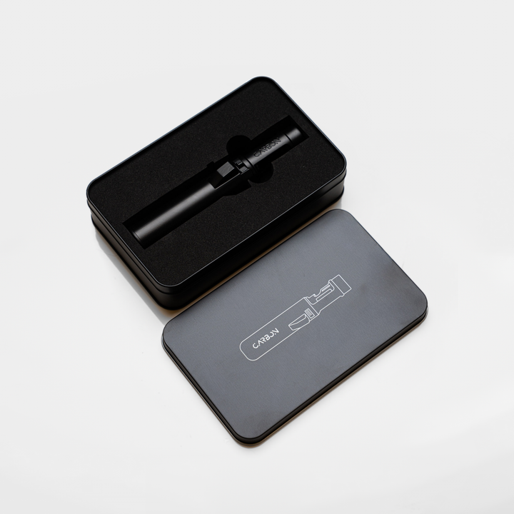 Carbon Ignis torch lighter in its open black tin